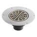 A Sioux Chief round metal floor drain with a round metal cover.