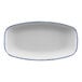 A white rectangular porcelain platter with a sponged blue rim.