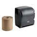 A Lavex translucent black lever activated paper towel dispenser with a roll of brown paper towels inside.