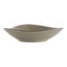 A white bowl with brown specks and a green and brown rim.