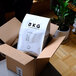 A white box with a black bag of BKG Brazil Black Whole Bean Coffee inside.