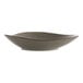 A white stoneware bowl with brown specks.