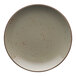 A white stoneware coupe plate with red specks.