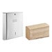 A stainless steel multifold paper towel dispenser with a stack of kraft M-fold paper towels.