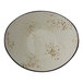 A white bowl with brown specks on it.