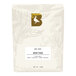 A white bag of BKG Heritage whole bean coffee with a black logo and label.