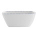 A white bowl with blue speckles on it.