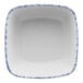 A white square porcelain bowl with a blue sponged border.