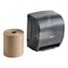 A black Lavex automatic paper towel dispenser with 6 rolls of paper towels inside.