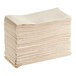 A large stack of beige Choice Touchstone linen-feel paper guest towels.