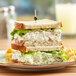 A sandwich with Don's Salads white meat chicken salad on a plate.