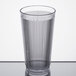 A close-up of a Carlisle clear plastic tumbler with a straight rim.