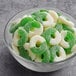 A bowl of Albanese Green Apple Gummi Rings and white candy.