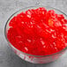 A bowl of Albanese Strawberry Gummi Bears on a table.