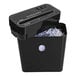 A black Royal CX10 paper shredder with shredded paper in a black container.