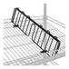 A black metal slanted shelf divider on a metal rack.