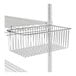 A Regency chrome storage basket attached to wire shelving.