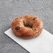 A Just Bagels chocolate chip bagel on a white napkin.