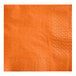 A close-up of a white Choice Orange 2-ply beverage napkin with a diamond pattern in orange.