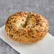 A Just Bagels pre-sliced everything bagel with seeds on it.