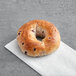 A Just Bagels blueberry bagel on a white napkin.