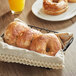 A basket filled with Just Bagels French Toast Bagels on a table.