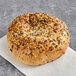 A Just Bagels Everything Bagel with seeds on it.