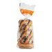 A white bag with orange and black text containing Just Bagels frozen everything bagels.