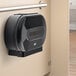 A black Lavex double roll toilet tissue dispenser on a wall.