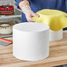 A man holding a Baker's Lane foam round cake dummy.