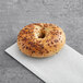 A Just Bagels garlic bagel on a white napkin.