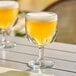Two Libbey Hoffman House Schooner glasses of beer on a table.