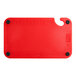 A red plastic Choice cutting board with a handle and rulers.