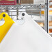 A white Choice cutting board on a metal rack.