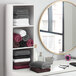 A shelf in a room with white gym and salon towels.