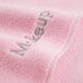 A pink Monarch Brands wash cloth with the word "makeup" in coral text.