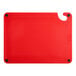 A red plastic Choice cutting board with a handle and rulers.