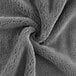 A close up of a grey Monarch Brands coral fleece hand towel.