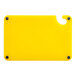 A yellow plastic Choice cutting board with a handle and rulers.