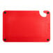 A red plastic Choice cutting board with grips and rulers.