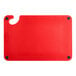 A red plastic Choice cutting board with a handle, hooks, and rulers.