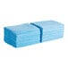 A stack of blue Tork Z-Fold Food Service wipers.