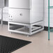 A stainless steel MainStreet Equipment undercounter dish machine on a metal stand.