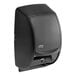 A black Tork double roll toilet paper dispenser.