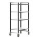 A black metal Cambro Camshelving unit on wheels with four shelves.