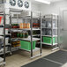 A Cambro Camshelving Elements XTRA add-on unit in a large walk-in freezer.