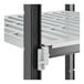 A close-up of a white plastic Cambro Camshelving shelf with vented shelves.