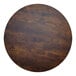 A BFM Seating round wood table top with a dark brown finish.