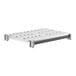A white plastic Cambro Camshelving shelf with vented metal inserts.