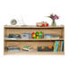 A Flash Furniture wood classroom storage cabinet with books and toys on the shelves.